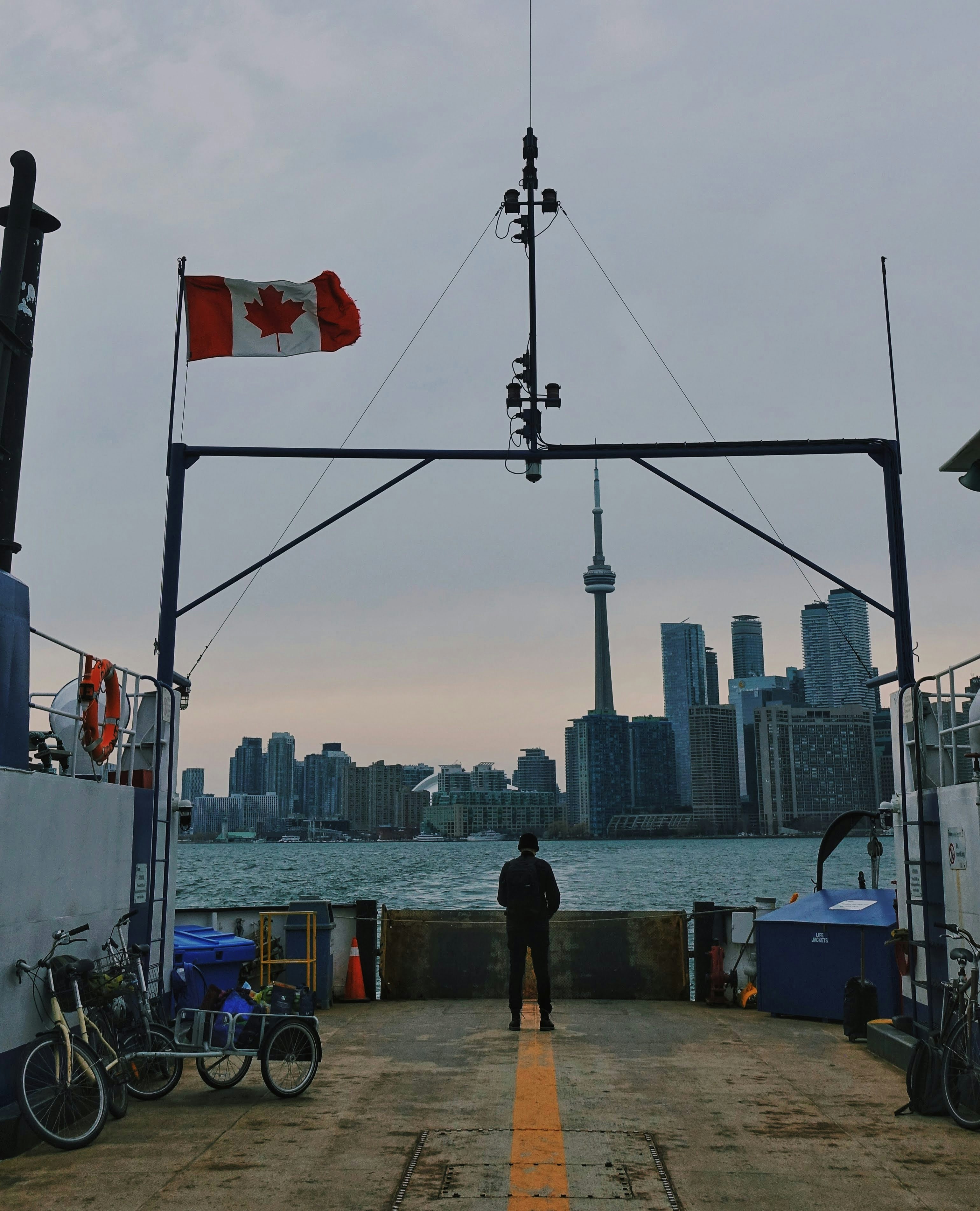 Canadian flag waving with Toronto skyline in background representing immigration opportunities